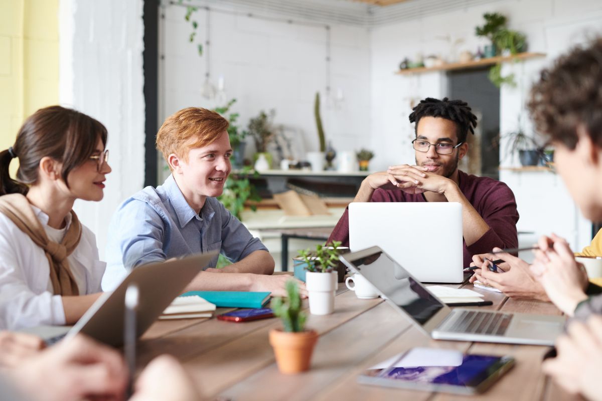 Developers, designers and project leads working through a problem together