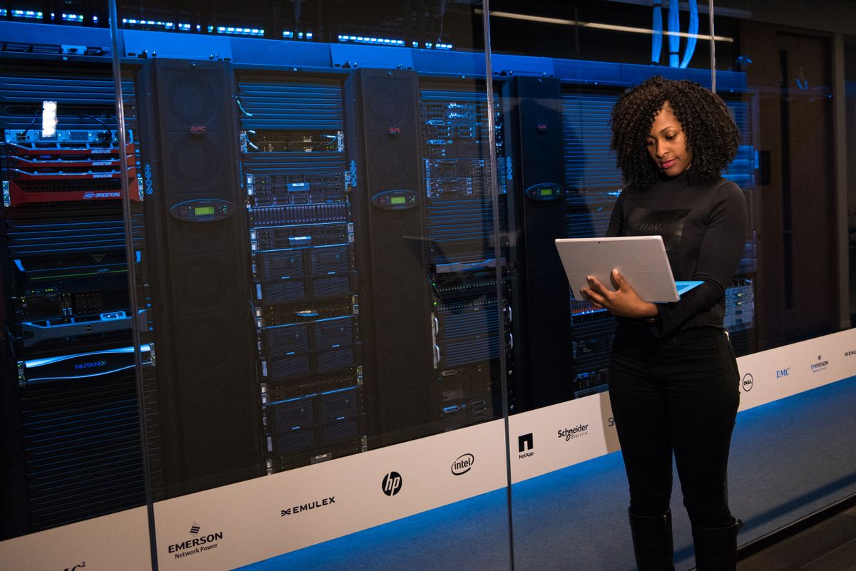 Engineer reviewing infrastructure alongside production servers