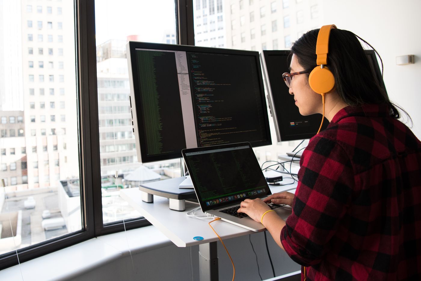 Engineer investigating production behaviour across development screens